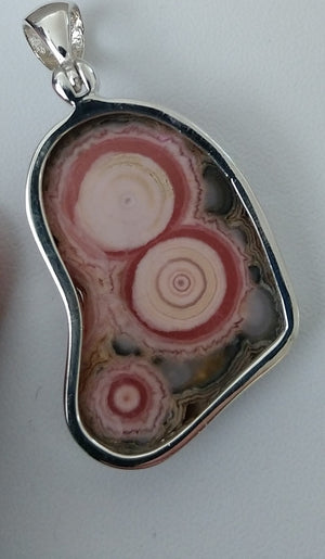 Rhodochrosite stalactite slice pendant